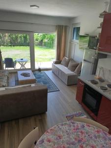 a living room with a couch and a table at Apartman Una na dlanu, Novi Grad in Bosanski Novi