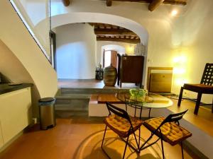 a room with a table and chairs in a building at Fortress overlooking the sea in Porto Ercole
