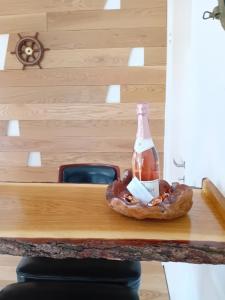 a bottle of beer and a bagel on a table at Bed and Boat in Præstø