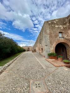 an old stone building with a cobblestone street at Fortress overlooking the sea in Porto Ercole