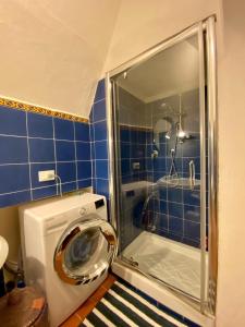 a washing machine in a bathroom with a shower at Fortress overlooking the sea in Porto Ercole +46 photos