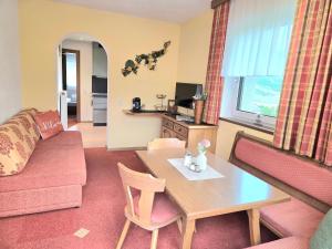 a living room with a couch and a table at Piz Arina Inklusiv Premium - Card in Galtür