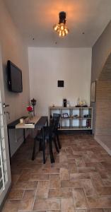 a dining room with a table and chairs and a television at A Casa di Dody in Guidonia
