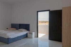 a bedroom with a bed and a window with a view at Villa Berka in Barka +16 photos