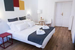 ローマにあるSuite Cardinaleのベッドルーム1室(大きな白いベッド1台、タオル2枚付)