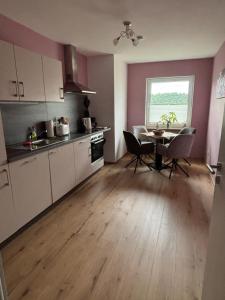 a kitchen and dining room with a table and chairs at Villa Basilika - Ferienwohnung Prüm in Prüm