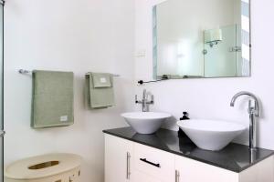 a bathroom with a sink and a toilet and a mirror at The Olive Edit in Batemans Bay +73 photos