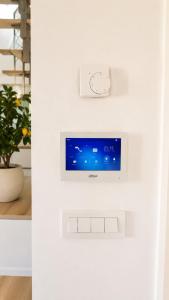 a television on a wall in a room at Valora Central Apartment in Vrhnika +5 photos