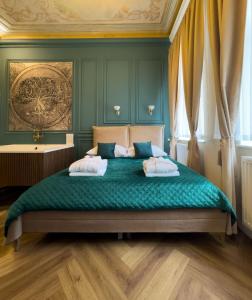 a bedroom with a green bed with two pillows at Apartament z Jacuzzi Kraków ART Koletek in Krakow