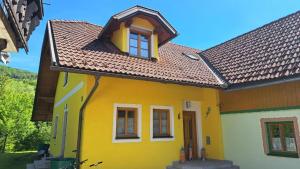 a yellow and white house with a brown roof at Ferienvilla Schwarzenbach in Schwarzenbach an der Gölsen