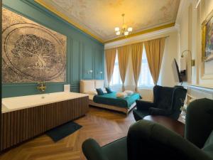 a bathroom with a tub and a bed in a room at Apartament z Jacuzzi Kraków ART Koletek in Krakow