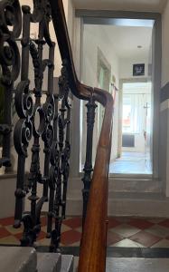 a wooden staircase with a wooden rail in a building at Apartments Centrum in Rožnov pod Radhoštěm