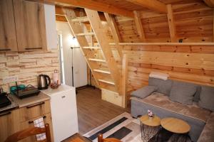 a living room with a couch and a staircase in a cabin at Zekova Valley Cabin Durmitor in Žabljak