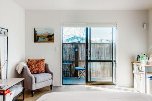a bedroom with a door leading to a balcony at The Albert Studio in Albert Town