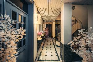 a hallway with a blue door and a plant at Royal Hotel in Cairo