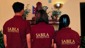 a group of three people wearing red shirts at Sabila Boutique Hotel in Kathmandu