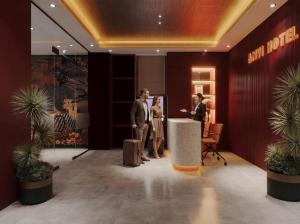 a group of people standing in a lobby with luggage at Anvi Boutique Hotel Hanoi in Hanoi