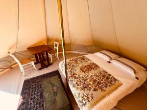 a room with a bed and a table in a tent at Natur'O Médoc in Naujac-sur-Mer