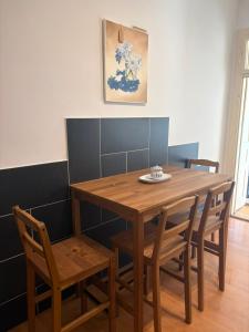 a wooden table and chairs with a plate on it at Ferienwohnung Zum alten Postamt in Mörbisch am See +6 photos