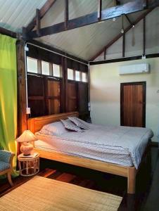 a bedroom with a bed in a house at Tamarind nest in Sai Yok