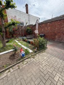 a person sitting on a bench in a garden at Cozy Room for 2 people in Dresden