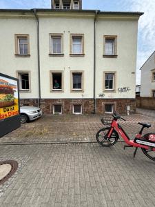 a red bike parked in front of a building at Cozy Room for 2 people in Dresden