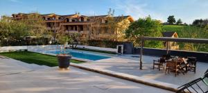 a backyard with a swimming pool and a house at A Casa di Dody in Guidonia