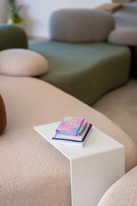 a stack of books sitting on top of a white table at Villa FUX Eternity 3 in Ždrelac +30 photos