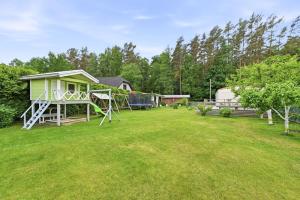 a yard with a house and a playground at Vagunmaja in Haapsalu