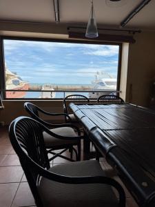 a table and chairs with a view of a boat at Двоповерхові апартаменти в яхт-клубі in Odesa