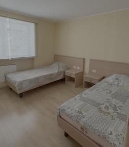 a bedroom with two beds and a window at Двоповерхові апартаменти в яхт-клубі in Odesa