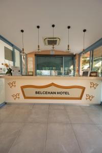 a sign for a bichenan hotel in a building at Belcehan Hotel in Oludeniz +112 photos