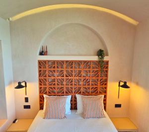a bedroom with a bed with two striped pillows at Ca' Mare luxury suite in Mesongi