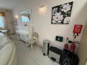 a living room with a couch and a piano at S'Agapo Maisonette St' Julians in St. Julianʼs