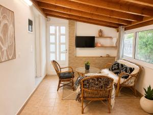 a living room with a table and chairs at The simple two-bedroom house at Klima Beach in Samos