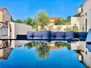 a blue couch sitting on top of a pool at Apartment Bellaria in Jadranovo