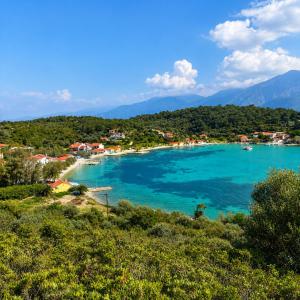 a view of a beach with boats in the water at The simple two-bedroom house at Klima Beach in Samos
