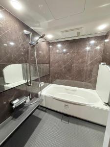 a bathroom with a tub and a toilet and a sink at Central Roppongi House in Tokyo