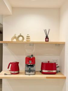 a kitchen with two red appliances on a shelf at Central Roppongi House in Tokyo +15 photos
