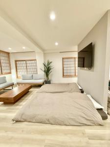 a bedroom with a large bed in a room with windows at Central Roppongi House in Tokyo