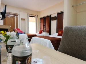 a hotel room with two beds and two bottles of water on a table at Hotel Yahalis in Jilotepec de Abasolo