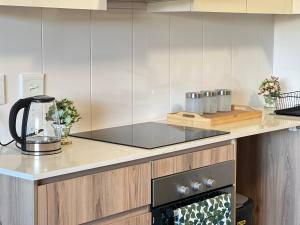 a kitchen with a counter with a stove top oven at Luxury Apartment Overlooking the River in Midrand