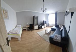 a living room with a couch and a bed at Apartman Kováčová in Kováčová
