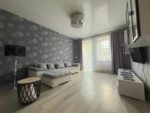 a living room with a couch and a table at Lielais prospekts 54 in Ventspils
