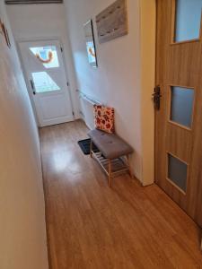 a small room with a chair and a door at Apartman Kováčová in Kováčová
