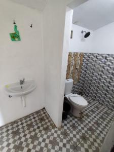 a bathroom with a toilet and a sink at Laendra Sunset Karimunjawa in Karimunjawa
