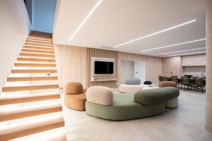 a living room with a couch and a tv and stairs at Villa FUX Eternity 3 in Ždrelac
