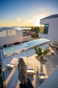 a patio with lounge chairs and a swimming pool at Villa FUX Eternity 3 in Ždrelac