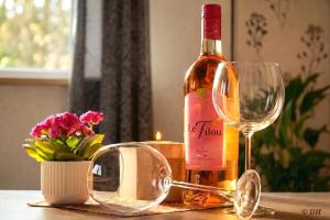 a bottle of wine and a glass on a table at Ferienhaus Flotte Biene Buggow nahe Usedom in Rubkow +13 photos