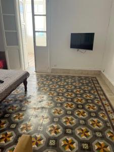 a room with a floor with a tv on a wall at 3 bedroom Villa with garden in Ez Zahra